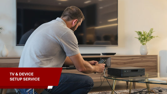 Man setting up a TV and device in a living room with text 'TV & Device Setup Service'.